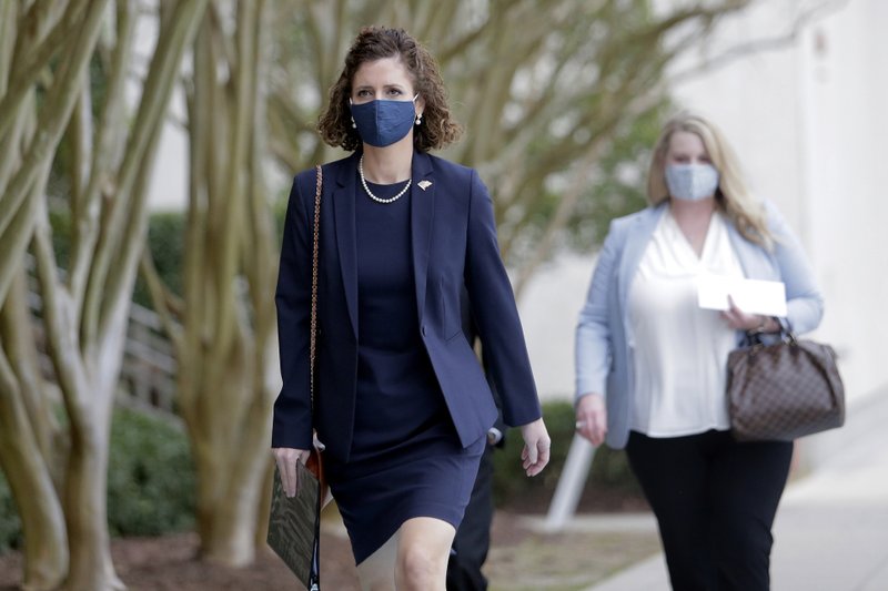 Julia Letlow, widow of Republican U.S. Rep.-elect Luke Letlow, makes her way into the Louisiana State Archives to sign up to run for the 5th District seat on Thursday, Jan. 21, 2021, in Baton Rouge, La. Luke Letlow won a December election for the congressional seat but died of COVID-19 complications in December, before he could be sworn into office. (AP Photo/Brett Duke)